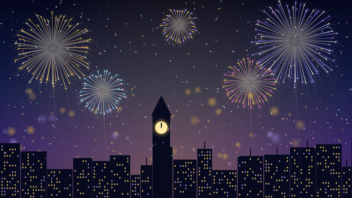 Fireworks over a city skyline at midnight on New Year's Eve